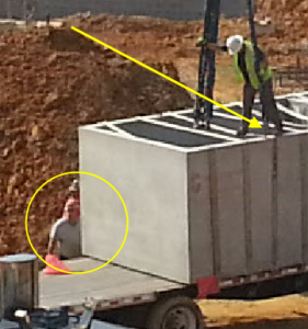 Notice the lack of PPE and fall protection in this detail image.
